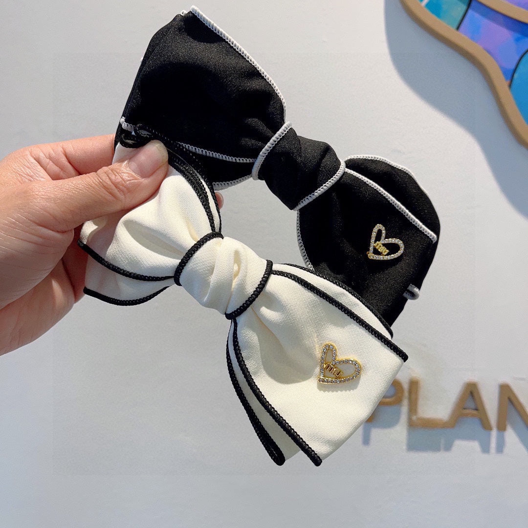 CHANEL BOW HAIRPIN IN WHITE AND BLACK TRIM COTTON 406023